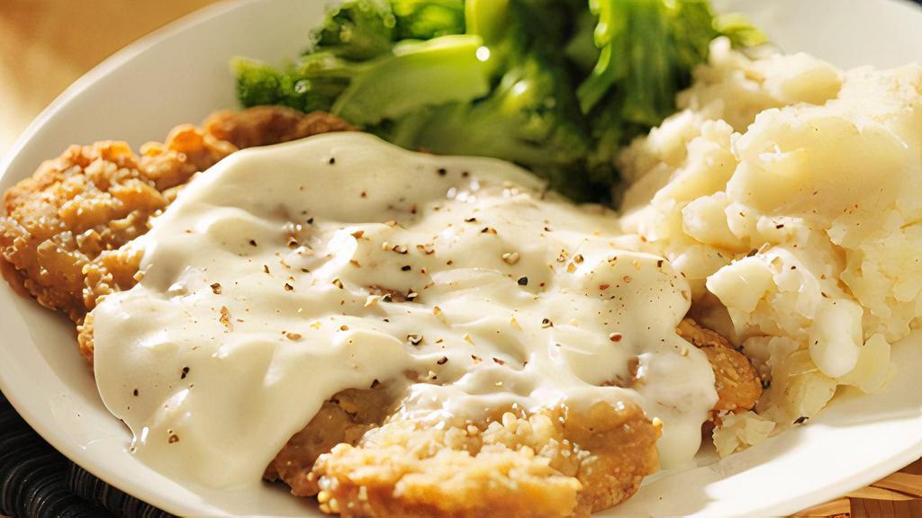 Country Fried Steak · Tender steak breaded in our signature seasoned flour, cooked to a golden brown, and topped with our traditional white gravy. Served with a choice of 2 sides.