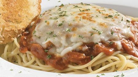 Baked Spaghetti · Spaghetti ladled with our rich tomato and meat sauce. Topped and baked with mozzarella cheese. Served with garlic bread.