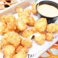 Cheese Curds · White Wisconsin cheddar cheese curds breaded fried until golden brown and served with our ch...