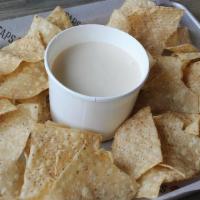 White Cheddar Dip & Chips · Tortilla chips served with our creamy white cheese sauce