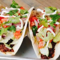 Tacos- Gringos · Two chicken or beef tacos with lettuce, tomato, onion, cheese and sour cream.  Served with c...