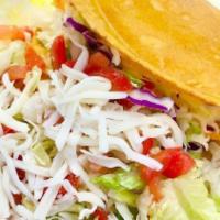 Taco Salad · Gluten-free. House-made corn chips topped with lettuce, your choice of protein, cheese, pico...