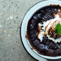 Molten Chocolate Pudding Cake · Fresh Whipped Cream, Mint, Chocolate & Caramel Sauces (V)