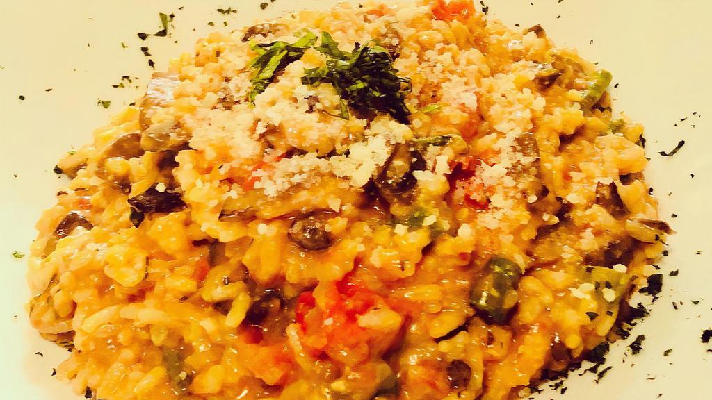 Mushroom Risotto · Herbs, Roma tomato, asparagus, and garlic, finished with Parmesan cheese.