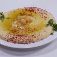 Hummus · A blend of chickpeas, tahini sauce and lemon, served with pita bread.