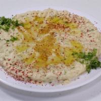 Baba Ghanoush · Eggplant blended with tahini, lemon and garlic, served with pita bread.