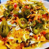 Muy Grande Nachos · Homemade crispy tortilla chips topped with refried beans, cheese, lettuce, tomato, Jalapeños...