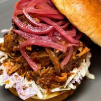 Carolina-Style Pulled Pork Sandwich · Beeler’s bone-in pork shoulder is marinated in our Smokeheads Signature Dry Rub and steadily...