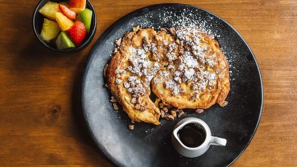 Croissant French Toast · Powdered sugar, warmed syrup, candied pecans side of fruit.