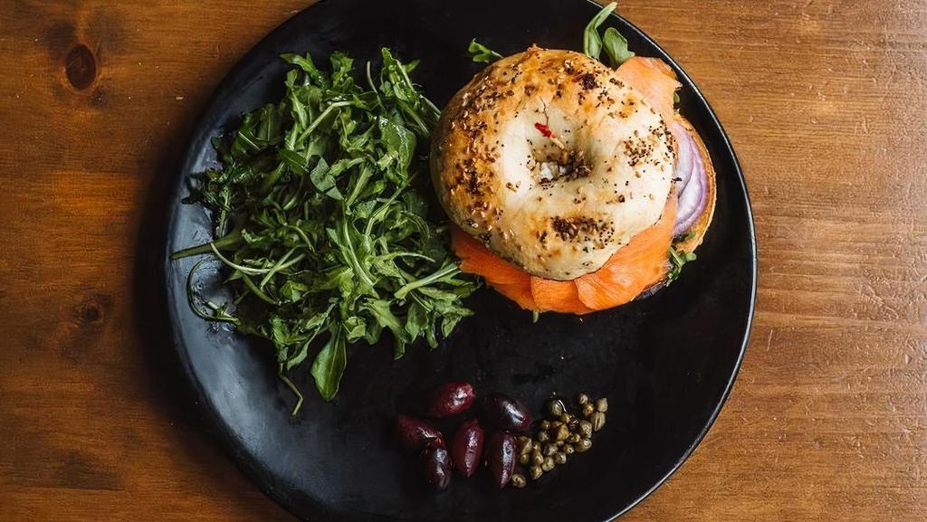 Ora-King Salmon Bagel · Sustainable smoked salmon, tomatoes, cream cheese, red onions, capers on toasted bagel.