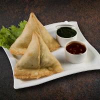 Samosa Royale · Cumin-flavored potatoes and peas filled in pastry dumpling and golden fried.