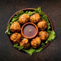 Crisp Veggie Fritters · Garden fresh assorted vegetable pieces dipped in spiced batter, and golden deep-fried.