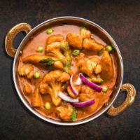 Basic Cauli Curry  · Pieces of cauliflower and potato cooked with vibrant flavors of fresh tomatoes, onions, ging...