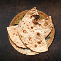 Clay Oven Baked Flatbread · Whole wheat flat bread baked to perfection in an indian clay oven.