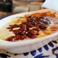 Queso Fundido · Melted cheese with Mexican sausage served with flour tortillas.