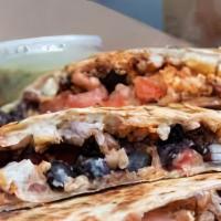 Quesadilla · Large quesadilla filled with steak and with grilled peppers.