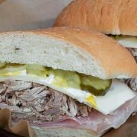Cubano Sandwich · Pulled pork, sliced ham, Swiss cheese, mayo, mustard and pickles on a toasted potato roll.