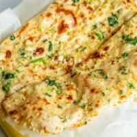 Garlic Naan · A traditional white flour bread with touch of garlic and cilantro. butter on top