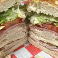 Deluxe Turkey Club · Turkey, ham, bacon, provolone, lettuce, tomatoes, and mayo.