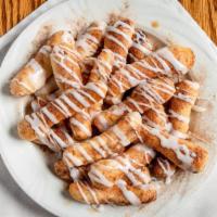 Cinnamon Stix · Breadstix topped with butter, cinnamon-sugar, and icing.