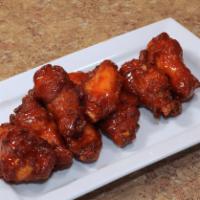 Chicken Wings · Classic bone-in wings, tossed around with our hot and spicy sauce.