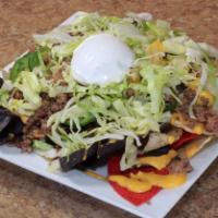 Ultimate Nachos · Rainbow tortilla chips, your choice of seasoned ground beef or chicken, sliced jalapeños, an...