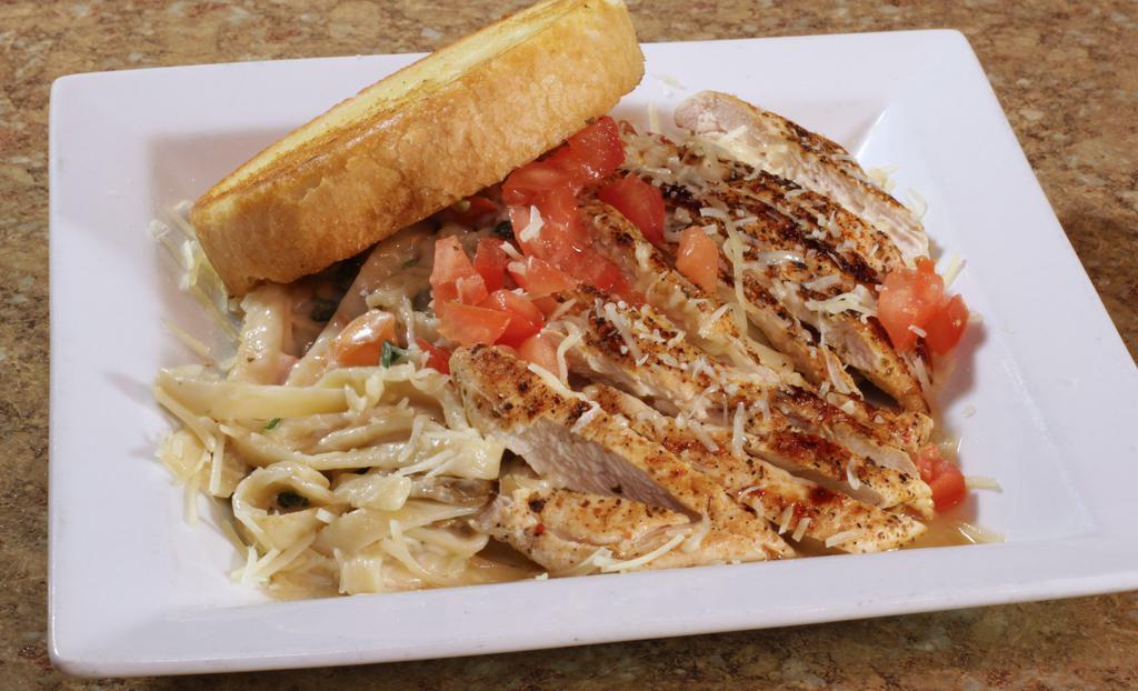 Chicken Alfredo Pasta* · Grilled seasoned chicken, fettuccine pasta, alfredo sauce, spinach, and mushrooms, topped with tomatoes and parmesan cheese.