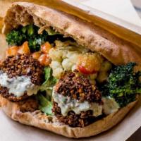 Falafel Sandwich · 5 Falafel balls in a freshly baked whole wheat or white pita with hummus and salad toppings.