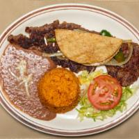Carne Asada Arrachera ​ · Tender grilled skirt steak. Thin cut served with grilled onion and jalapeños and cheese ques...