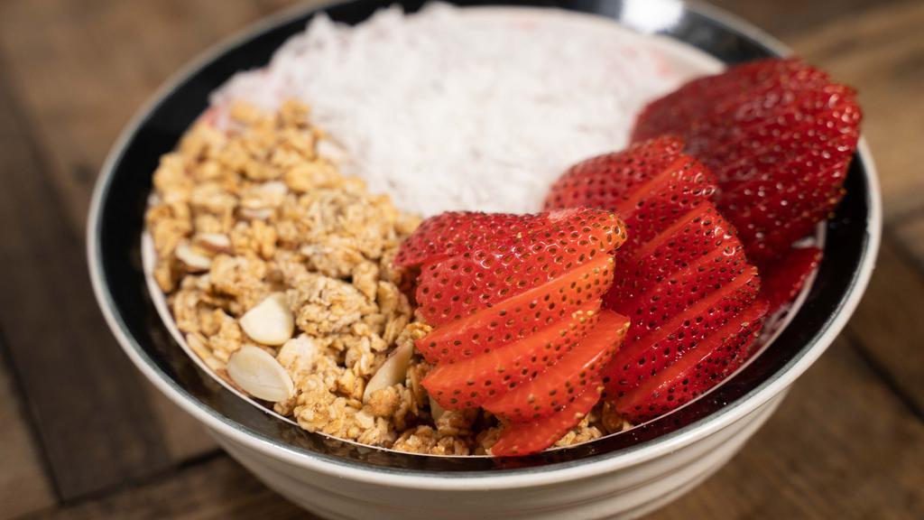 Strawberry Fields · Smoothie bowl with strawberries, vanilla & almond milk. Topped w/ granola, strawberries & coconut.