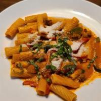 Vodka Pasta · Rigatoni pasta served with mild italian sausage and tri color bell peppers. Tossed in our vo...