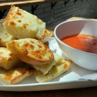 Garlic Bread W/Cheese · Our Baguettes covered in garlic butter and mozzarella cheese then baked and served with a si...
