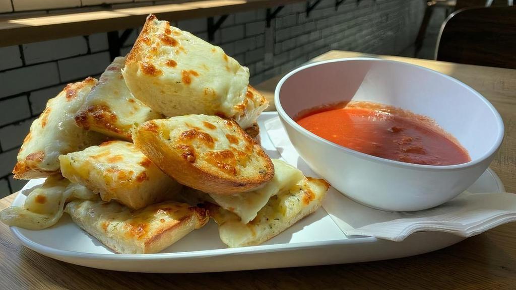 Garlic Bread W/Cheese · Our Baguettes covered in garlic butter and mozzarella cheese then baked and served with a side of homemade marinara sauce.
