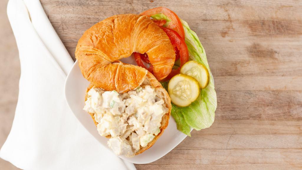 Chicken Salad Sandwich · Fresh chicken salad on a croissant, served with lettuce, tomato, and pickle.