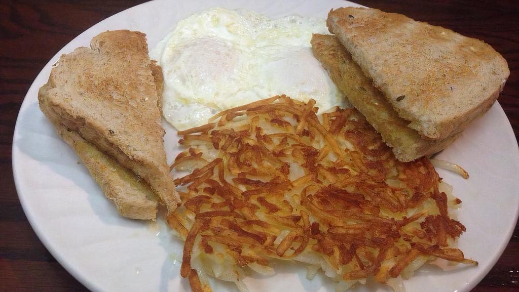 Two Eggs Any Style · Two eggs with options for meat potatoes and toast.
