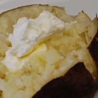 Smoked Potato · You’ve heard of baked. Well ours is smoked alongside our ribs slow and low to produce a tend...