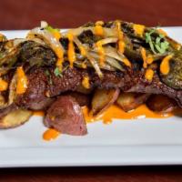 La Carne Asada · Adobo marinated grilled skirt steak served with herb roasted potatoes, roasted poblano peppe...