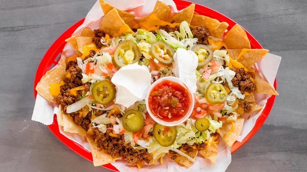 Nachos Supreme · Choice of steak (for an additional charge), chicken, beef or chili - lettuce + tomatoes + sour cream + raw onions + jalapeños + cheese + salsa on side.
