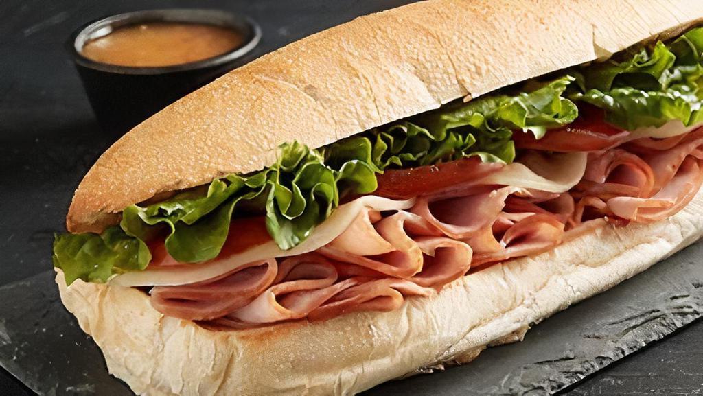 Ham & Cheese Sub · An American classic with ham, provolone, lettuce, tomato & Italian dressing.
