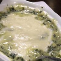 Spinach Artichoke Dip · Vegetarian. Fresh spinach artichoke dip topped with sour cream and served with warm chips