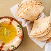 Hummus · Smooth dip of garbonzo beans, tahini sauce and garlic. Topped with olive oil and served with...