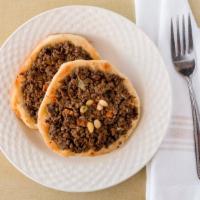 Sfeeha · Two pieces of homemade dough covered with freshly ground angus beef, diced tomatoes, pine nu...
