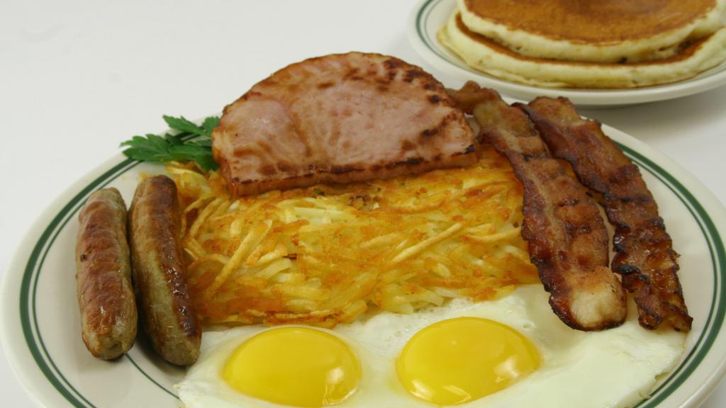 The Works Breakfast · 2 eggs, 2 bacon, 2 links, 2 ham, and 2 pancakes with hash browns.