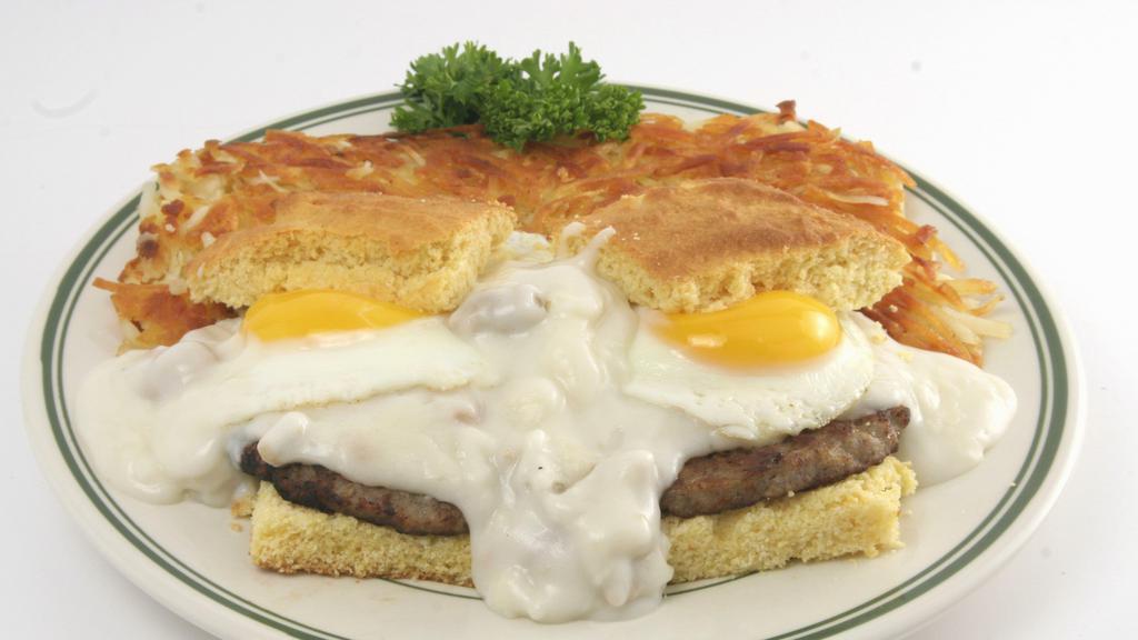 Corn Bread Benedict · Fresh baked cornbread topped with 2 sausage patties, and two eggs. Smothered with sausage gravy. Served with hash browns.