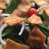 Fattoush   · Salad mix, parsley, tomatoes, onions, cucumber & pita chips, tossed with our house dressing.