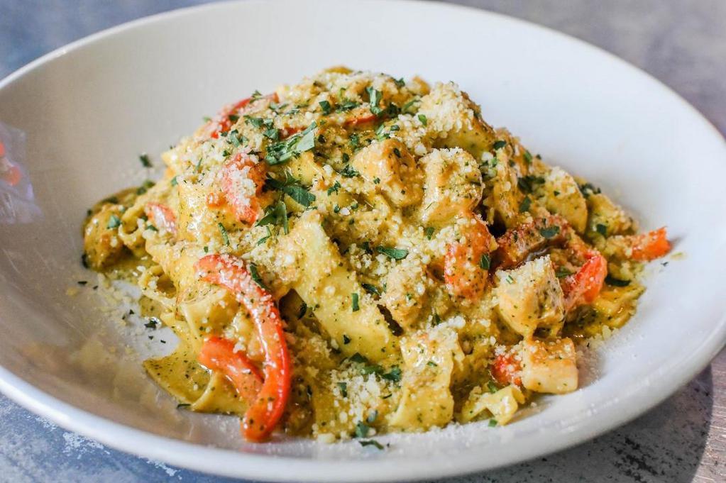 Chicken Pesto Pasta · sauteed chicken breast, pappardelle pasta, basil tomato mornay, parmesan, bell peppers, roasted garlic puree