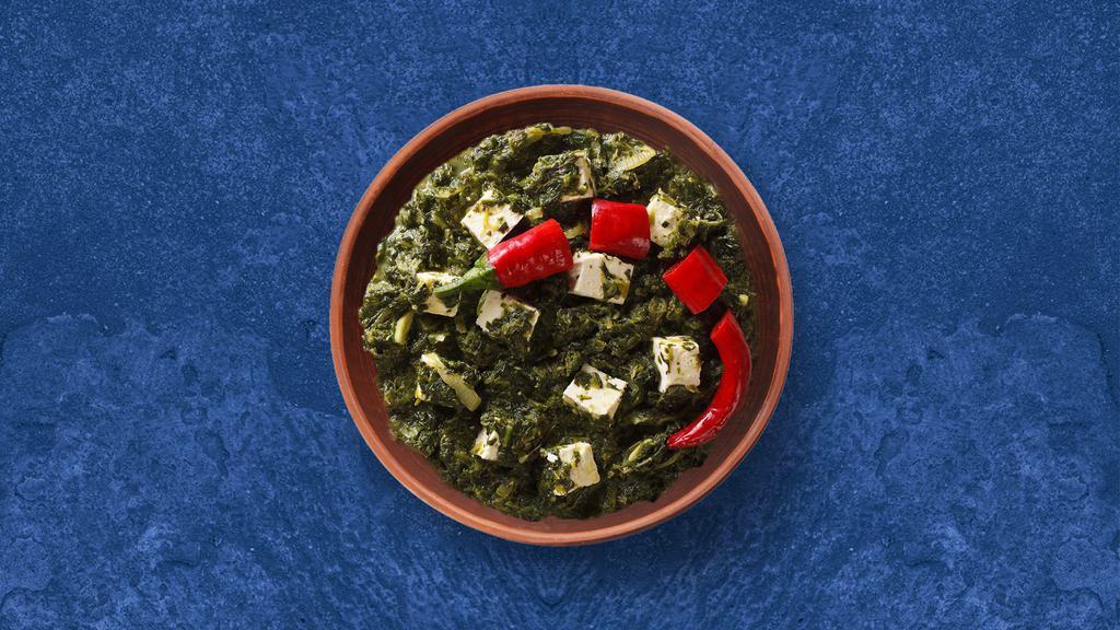 Spinach Cottage Cheese Showdown · Cottage cheese cooked in spinach curry with spices and onion, garlic and tomato. Served with a side of rice.
