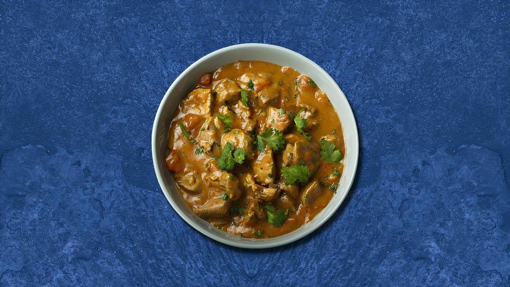 Clubhouse Chicken Curry · Chicken cooked with onion and a fresh and tangy tomato based sauce, seasoned with Indian spices. Served with a side of rice.