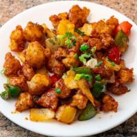 Gobi Manchurian · Fried cauliflower florets sautéed with onions, colored peppers, chilies, & manchurian sauce.
