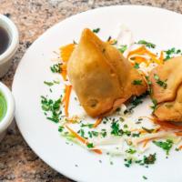 Veg Samosa · Deep-fried golden pastry stuffed with mildly spiced potatoes, & peas. Served with mint & dat...